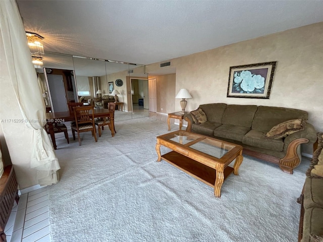 carpeted living room with a textured ceiling