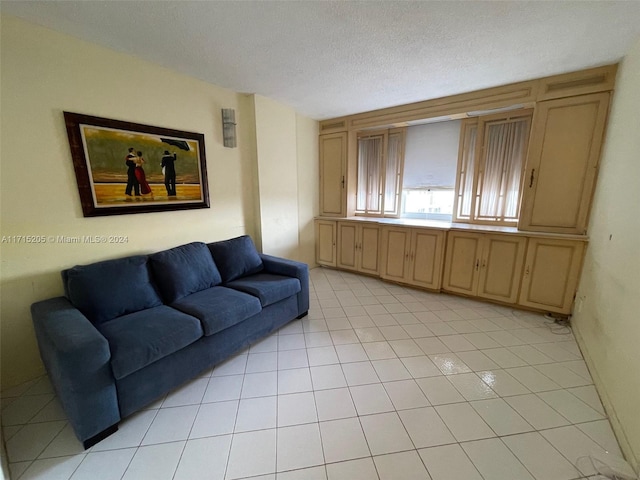 living room featuring light tile patterned floors and a textured ceiling