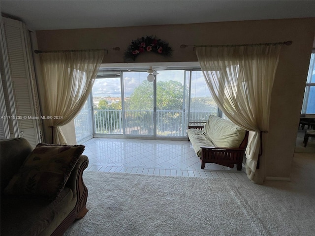 sitting room with ceiling fan and light tile patterned flooring