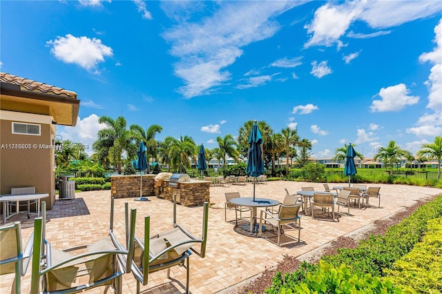 view of patio / terrace with central AC unit and exterior kitchen