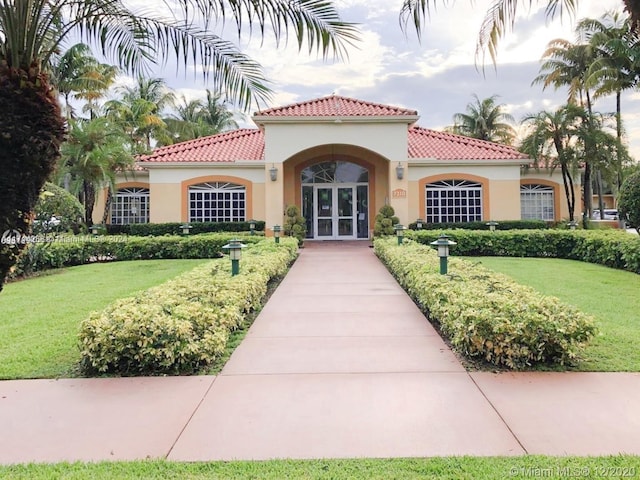 view of front of house featuring a front yard and french doors