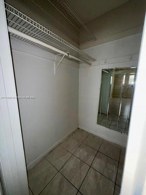 spacious closet with tile patterned flooring