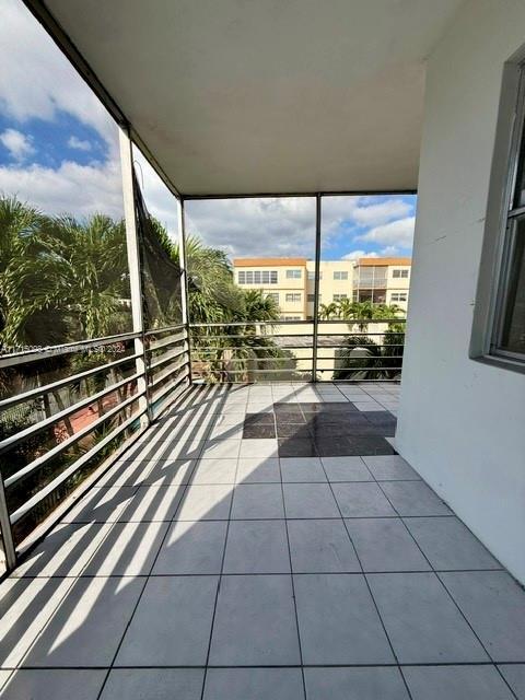 view of patio featuring a balcony