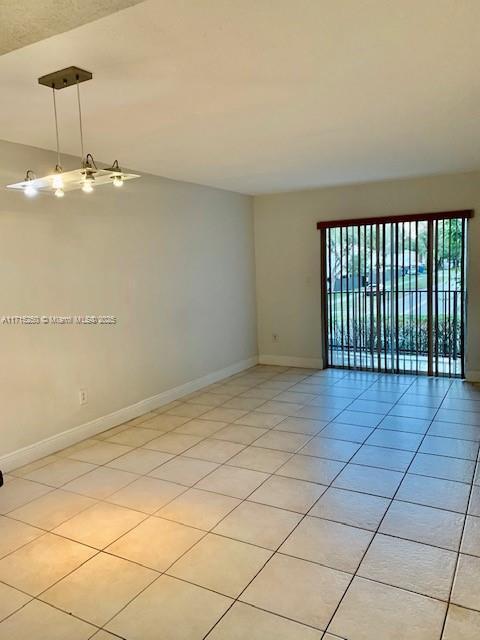 spare room featuring light tile patterned flooring