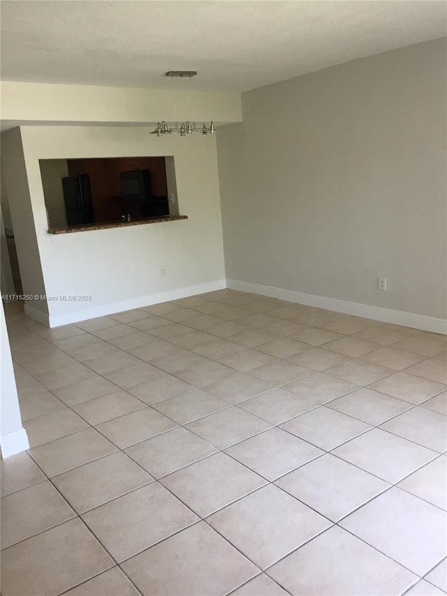 unfurnished room with light tile patterned floors