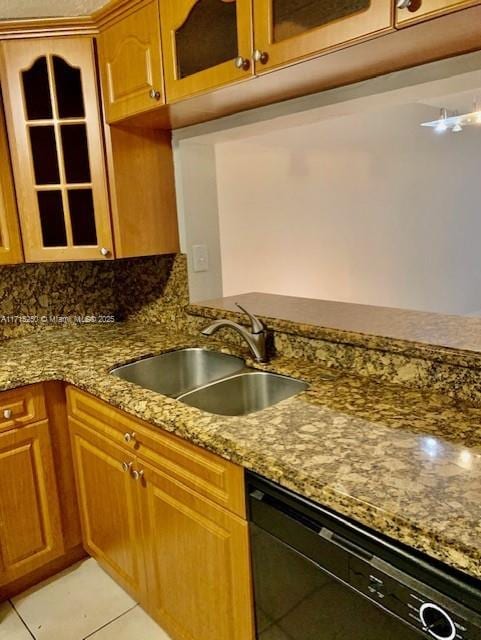 kitchen with stone counters, dishwasher, sink, tasteful backsplash, and light tile patterned floors