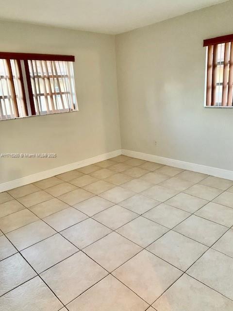 tiled empty room with plenty of natural light