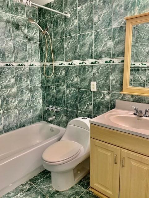 full bathroom featuring tile patterned flooring, tub / shower combination, toilet, vanity, and tile walls