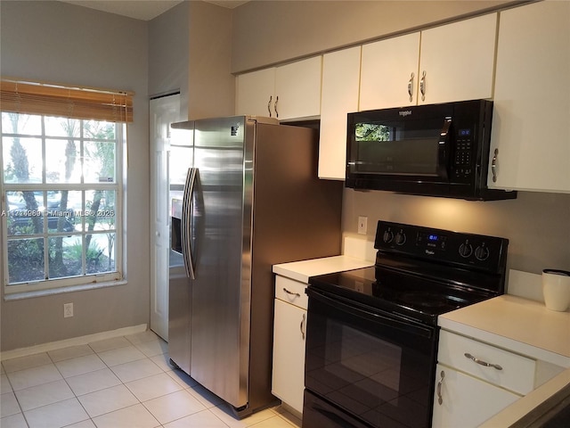 kitchen with black appliances, a healthy amount of sunlight, white cabinets, and light tile patterned floors