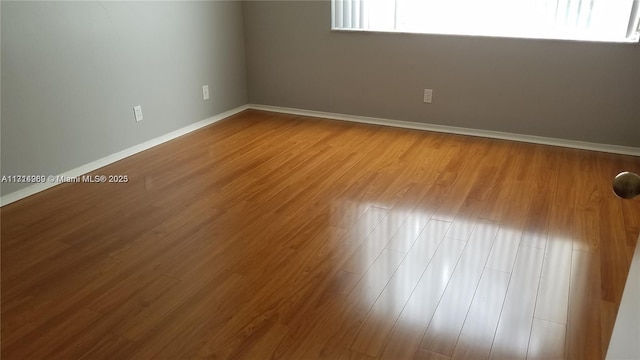 spare room with hardwood / wood-style flooring