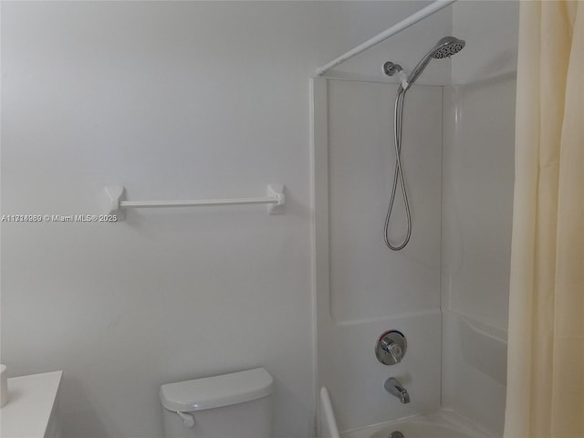 bathroom featuring shower / tub combo and toilet