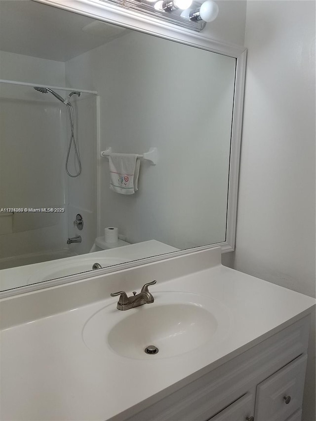 full bathroom with vanity, tub / shower combination, and toilet