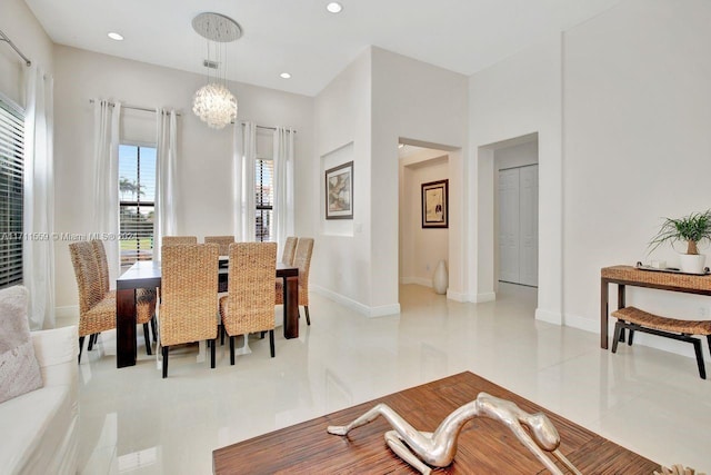 tiled dining room featuring a notable chandelier