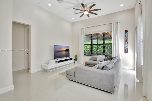 living room with ceiling fan and light tile patterned floors