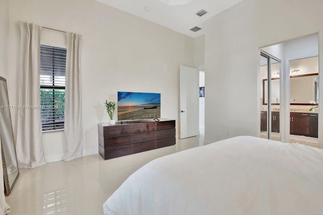 bedroom with ensuite bathroom and a closet