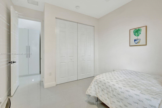 tiled bedroom featuring a closet