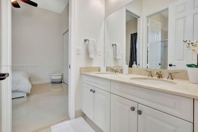 bathroom with tile patterned flooring, vanity, and ceiling fan