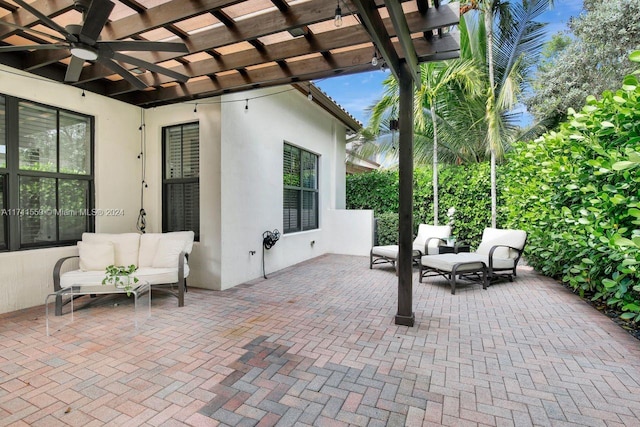 view of patio / terrace featuring an outdoor living space, ceiling fan, and a pergola