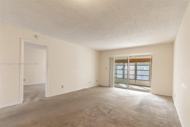 carpeted spare room with a textured ceiling