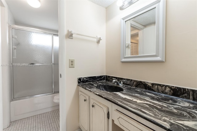 full bathroom with tile patterned flooring, vanity, toilet, and shower / bath combination with glass door