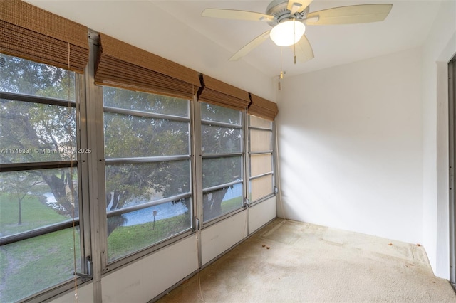 unfurnished sunroom featuring ceiling fan