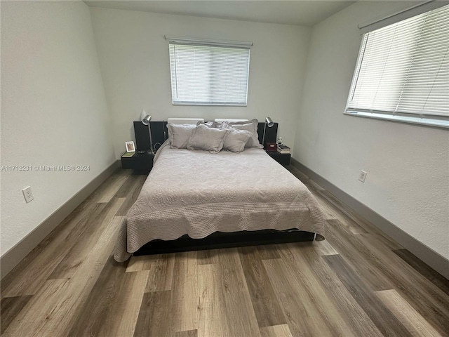 bedroom with hardwood / wood-style floors