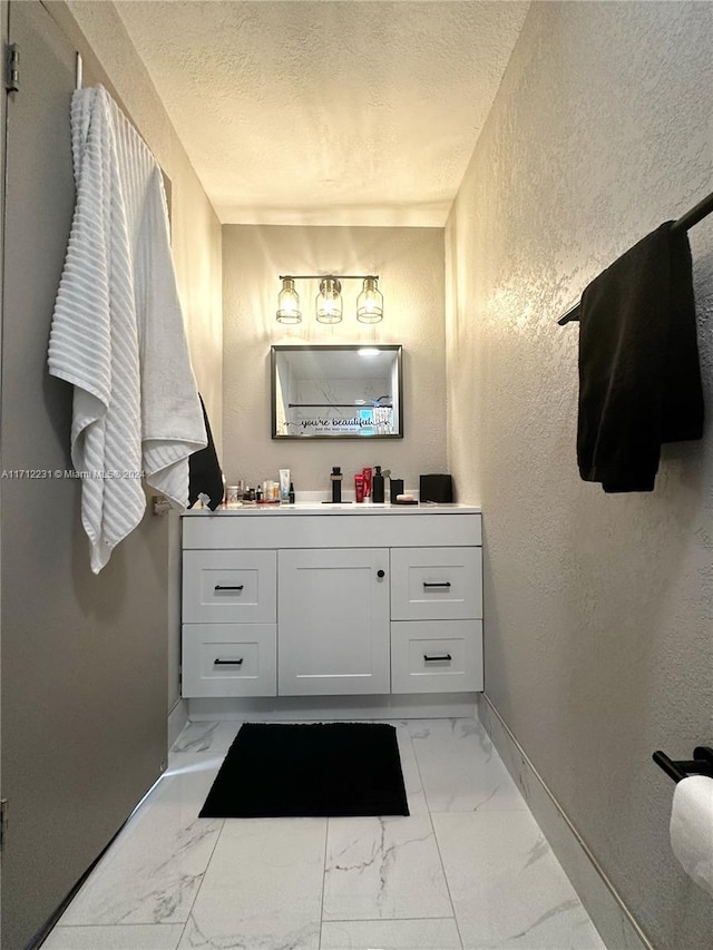 bathroom with vanity and a textured ceiling