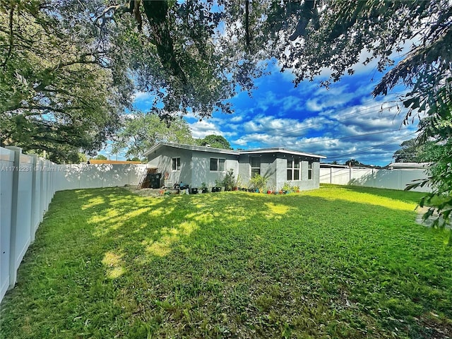 rear view of house with a lawn