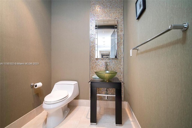 bathroom with tile patterned floors, vanity, toilet, and tasteful backsplash