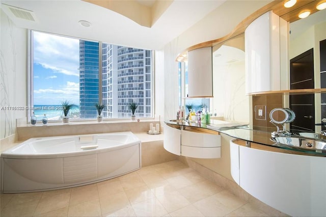 bathroom with vanity, a water view, tile patterned floors, and a bathing tub