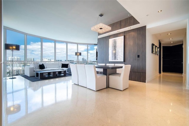 dining area featuring wood walls and expansive windows