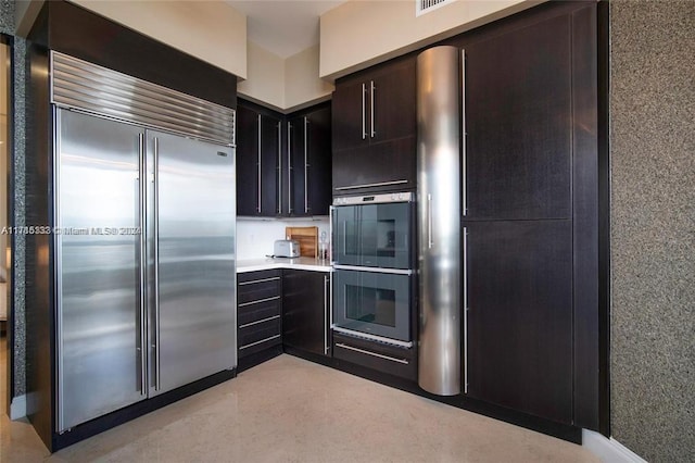 kitchen featuring black double oven and stainless steel built in fridge