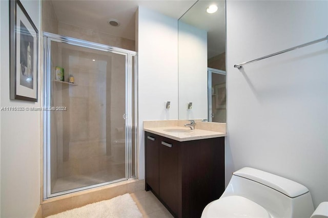 bathroom featuring tile patterned flooring, vanity, toilet, and walk in shower