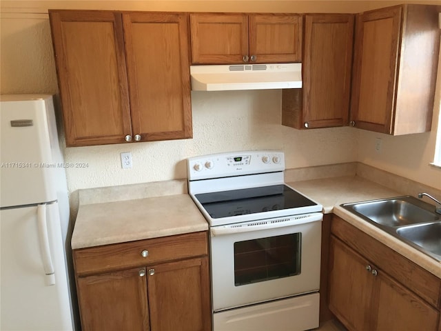 kitchen featuring sink and white appliances