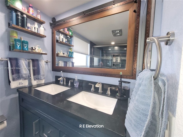 bathroom featuring an enclosed shower and vanity