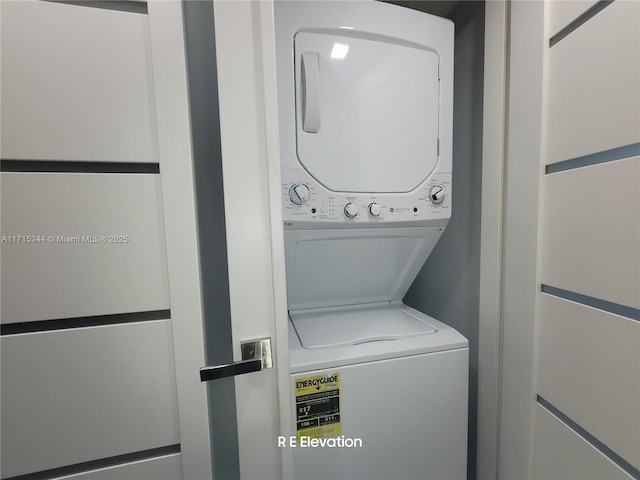 laundry room featuring stacked washer / drying machine