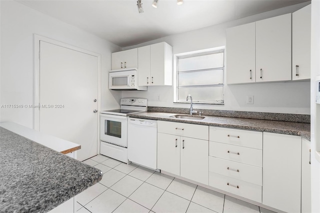 kitchen with white cabinets, light tile patterned floors, white appliances, and sink