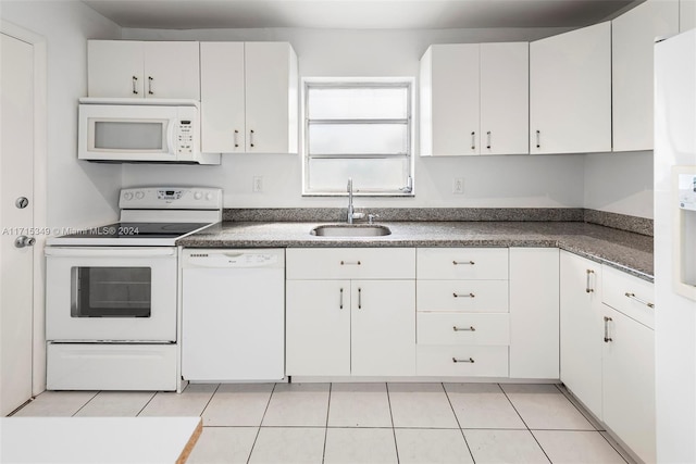 kitchen featuring white cabinets, light tile patterned flooring, white appliances, and sink