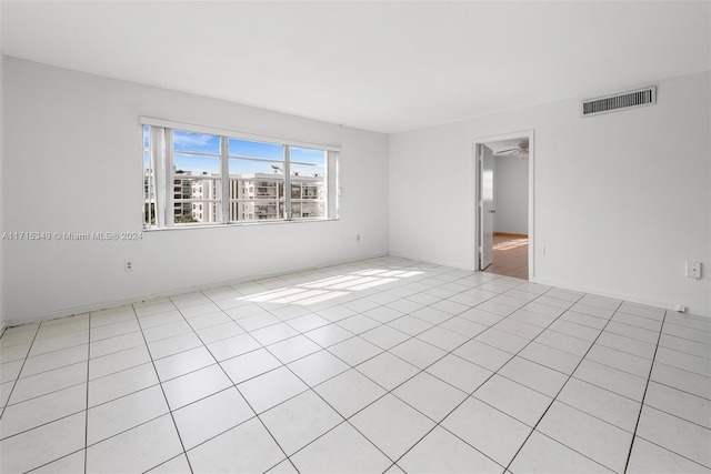 spare room featuring light tile patterned flooring