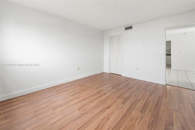 unfurnished room with light wood-type flooring