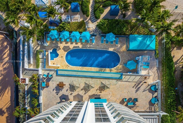 view of building exterior with a beach view and a water view