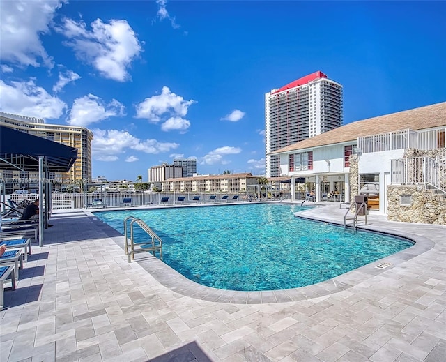 view of swimming pool with a patio