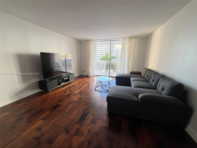 living room with dark hardwood / wood-style flooring and expansive windows