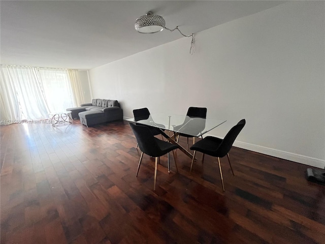 dining space with dark hardwood / wood-style flooring