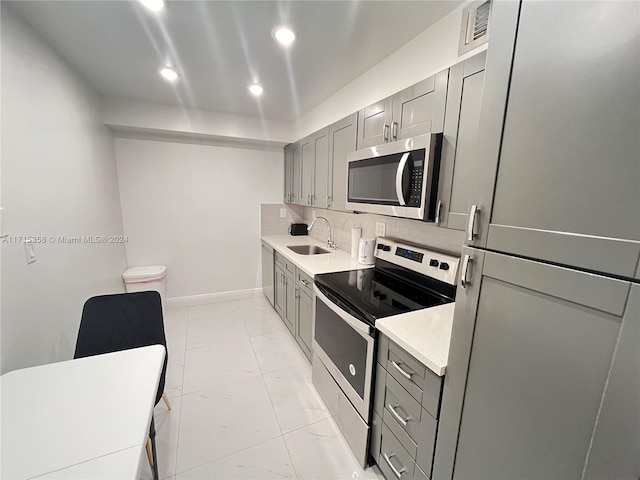 1849 S Ocean Dr Unit 409, Hallandale Beach, FL 33009 - kitchen featuring appliances with stainless steel finishes, gray cabinets, tasteful backsplash, and sink