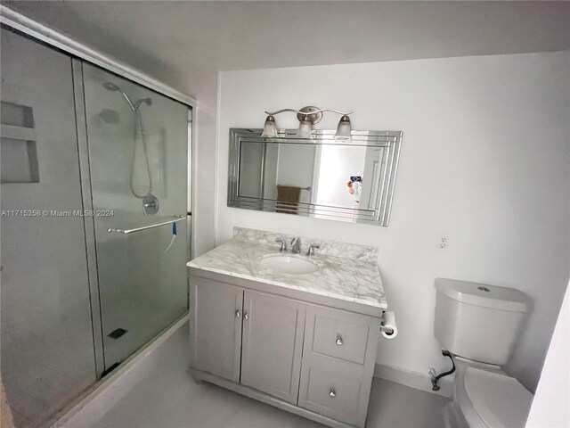 1849 S Ocean Dr Unit 409, Hallandale Beach, FL 33009 - bathroom with vanity, a shower with shower door, and toilet