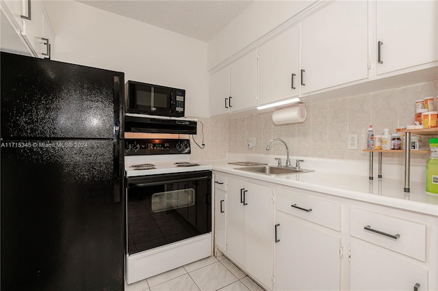 kitchen featuring light tile patterned floors, sink, white cabinetry, and black appliances