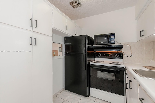 kitchen with black appliances, light tile patterned floors, a textured ceiling, tasteful backsplash, and white cabinetry