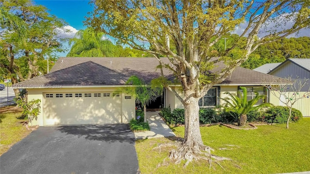 view of front of home with a garage and a front yard