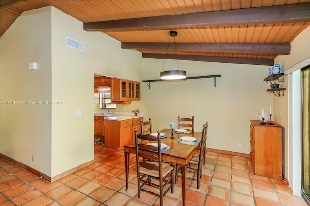 dining area with vaulted ceiling with beams, light tile patterned flooring, and wood ceiling